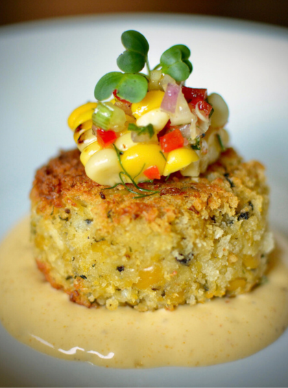 Vegan Chickpea "Crab Cake" Appetizer with Artichokes, topped with Charred Corn-Pepper Salsa.