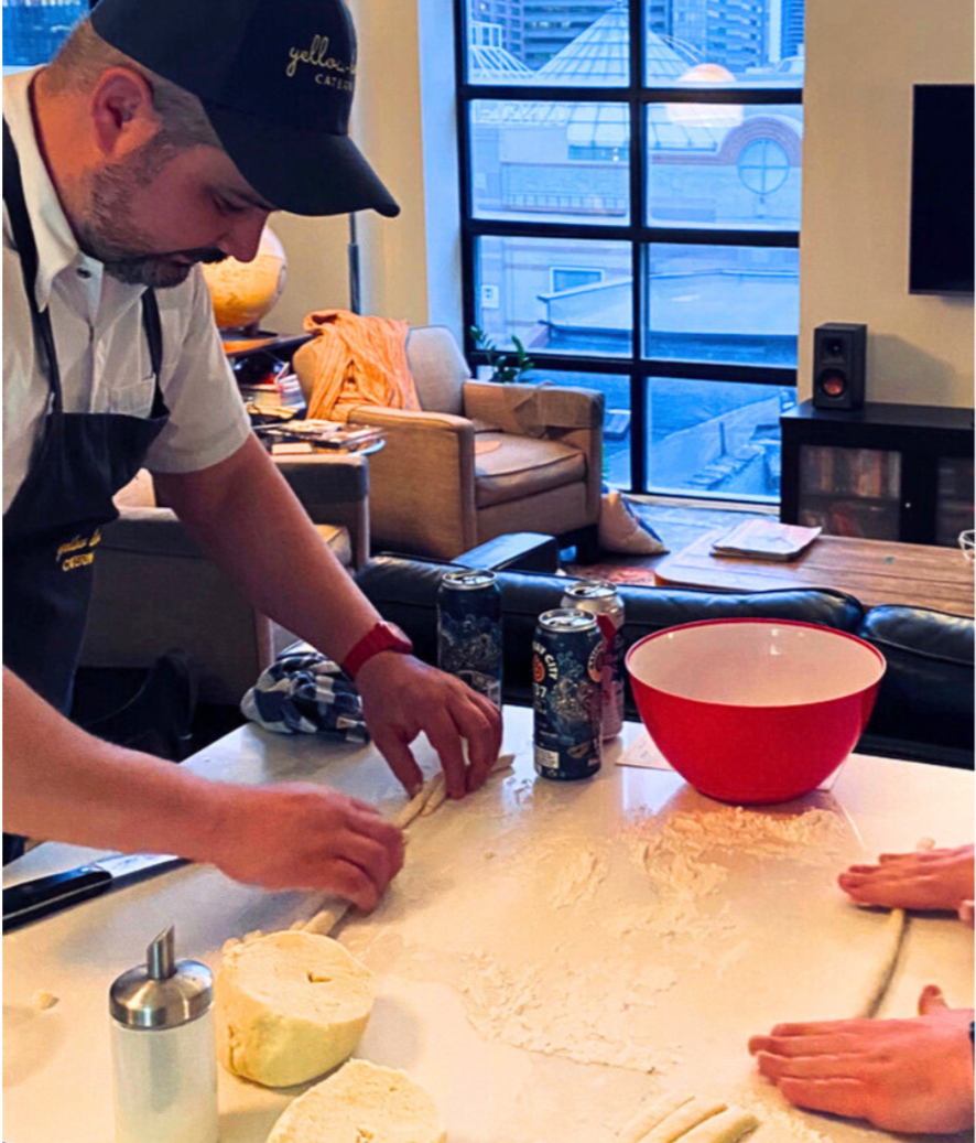 Chef Bill rolling gnocchi with a guest in an in-home cooking class