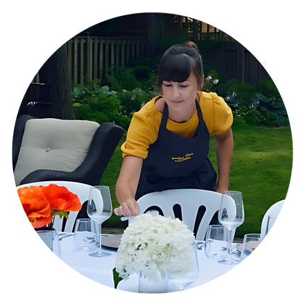 Andrea setting an outdoor table.